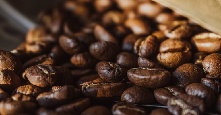 Rich, detailed close-up of aromatic roasted coffee beans showcasing texture and color.